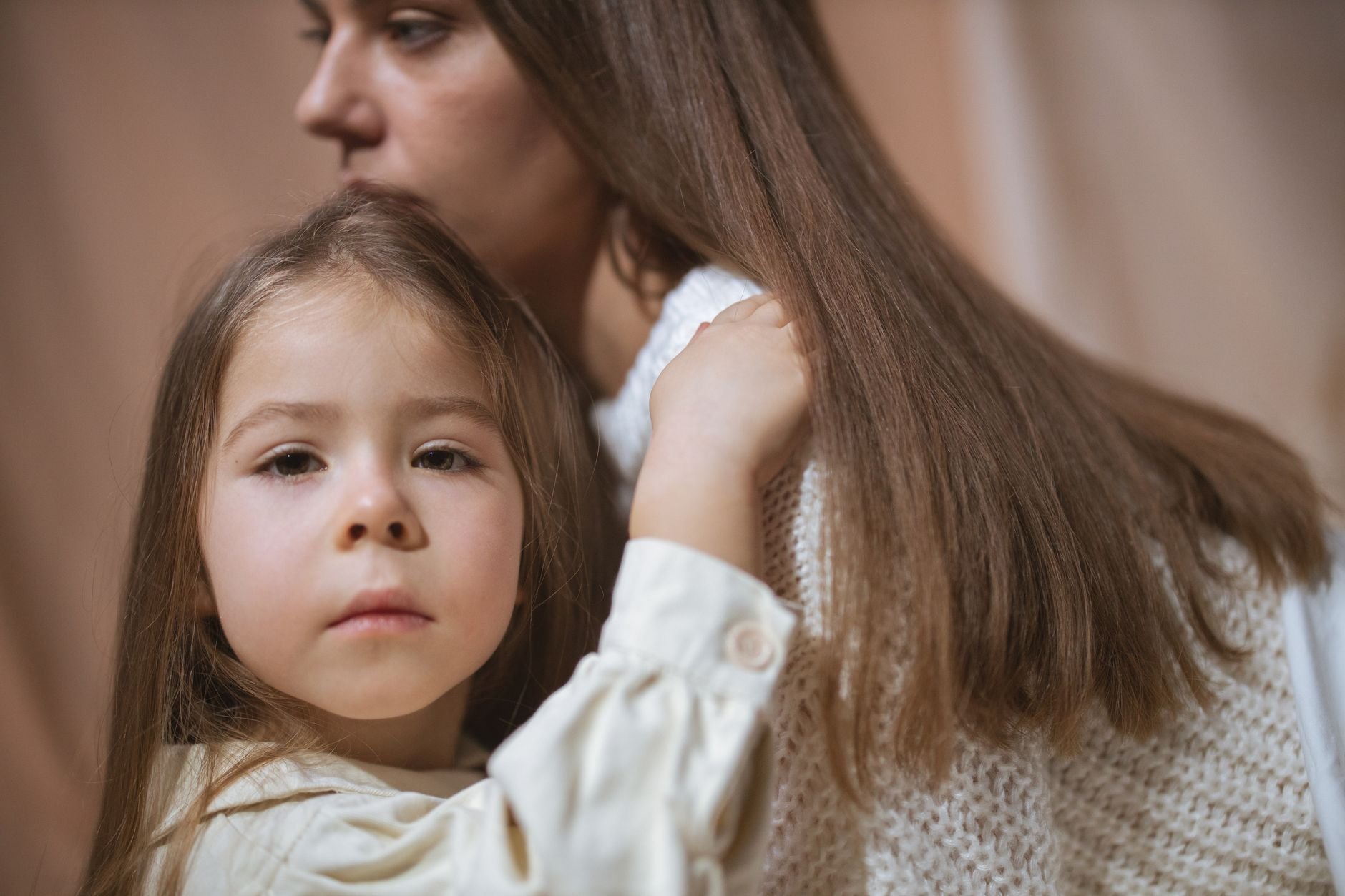 Tender moment between a mother and child embracing indoors, capturing love and connection